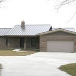 Energy-efficient "Green" Home, with ICF foundation, standing seam metal roof and solar panels in rear.