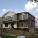 Siding and trim installation in progress.