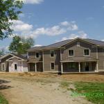 Front view of home - with siding, trim and roof now in place.