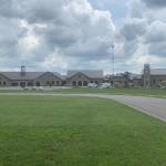 View of school, cafeteria, convent and chapel buildings during chapel construction